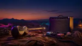 Persian tar beside a vintage guitar amplifier at desert twilight
